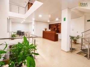 an empty lobby of a hotel with plants at Hotel Bambù 2 in Puerto Asís
