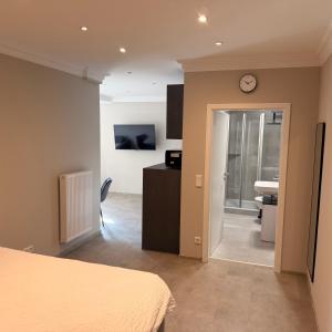 a bedroom with a bed and a clock on a wall at Apartment MessePark Bad Salzuflen in Bad Salzuflen