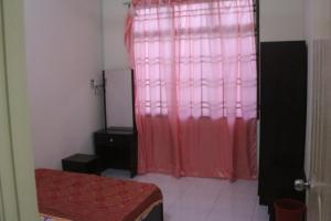 a room with a red curtain and a window at kluanghomestayvilla in Kluang