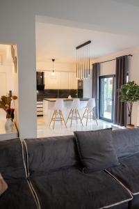 a living room with a couch and a kitchen at Divodi View in Mytikas
