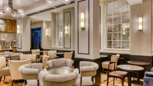 a restaurant with chairs and tables and a bar at hub London Farringdon - Old Bailey in London
