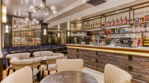 a bar with tables and chairs in a restaurant at hub London Farringdon - Old Bailey in London