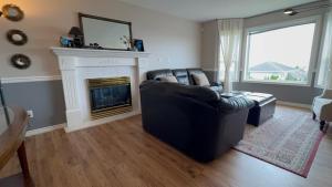 a living room with a couch and a fireplace at Ocean View Home Nanaimo in Nanaimo