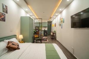 a bedroom with a bed and a tv on the wall at Hanoi Olive Boutique in Hanoi