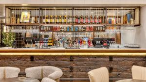 a bar at a restaurant with chairs and alcohol at hub London Farringdon - Old Bailey in London