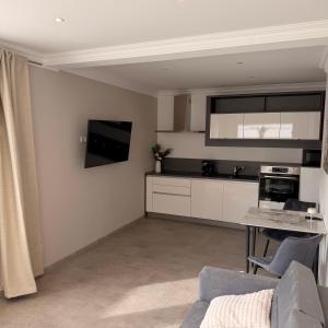 a living room with a couch and a tv on the wall at Apartment MessePark Bad Salzuflen in Bad Salzuflen