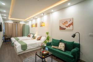 a hotel room with a bed and a couch at Hanoi Olive Boutique in Hanoi +39 photos