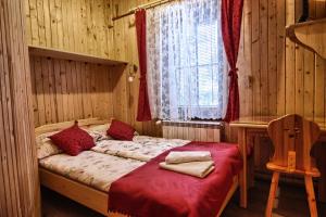 a bedroom with a bed in a wooden room at Pokoje Gościnne Za Wnukiem in Zakopane