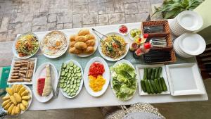 a table with many plates of food on it at Emerald Marina TL in Phú Quốc
