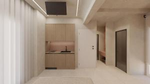 a kitchen with white walls and wooden cabinets at Pharos by Premium Key in Skiathos