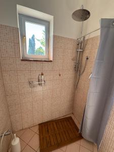 a shower with a window and a wooden mat in a bathroom at Casa della Consolazione in Todi +50 photos