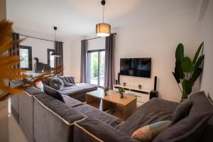 a living room with a couch and a table at Divodi View in Mytikas