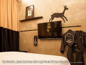 a tv with a picture of a deer on the wall at M Boutique Hotel in Ipoh