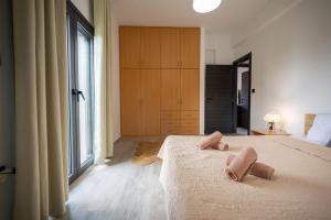 a bedroom with a large bed with two pillows on it at Divodi View in Mytikas