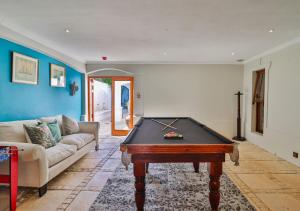 a living room with a pool table and a couch at Homestead Villas in Bellville