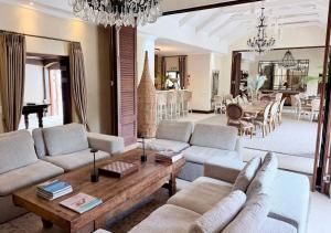 a living room with couches and a dining room at Homestead Villas in Bellville