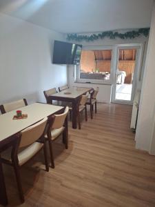 a dining room with tables and chairs and a window at Naab-burg in Nabburg