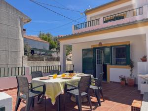 a patio with a table and chairs on a balcony at Port'Espada Countryhouse in Marvão