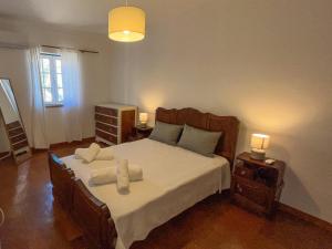 a bedroom with a bed with two towels on it at Port'Espada Countryhouse in Marvão +91 photos
