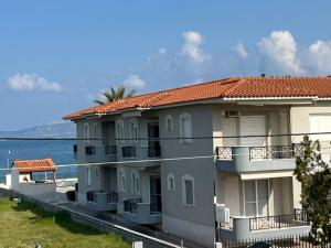 a large apartment building next to the water at Stella Maris sea front studios in Kanatádhika