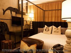 a bedroom with a bed and a desk and a tv at M Boutique Hotel in Ipoh