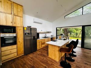 a kitchen with wooden cabinets and stainless steel appliances at Between Waves and Woods in Sámara