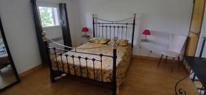 a bedroom with a bed and a table and two lamps at Kilomètre creusois in Saint-Dizier-Leyrenne