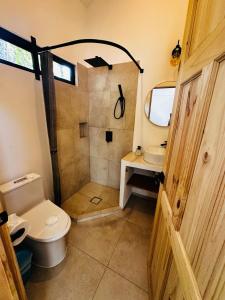 a bathroom with a shower and a toilet and a sink at Between Waves and Woods in Sámara +20 photos