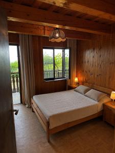 a bedroom with a bed in a room with windows at Weekendica in Fokovci