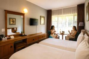 two women are sitting in a hotel room at Sundown Country Estate in Boshoek