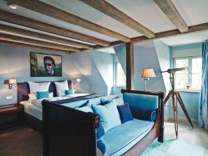 a bedroom with a bed and a chair in it at Auberge de Temple in Johannesberg +41 photos