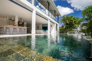 a swimming pool in the backyard of a house at Karibu House in Les Trois-Îlets +41 photos