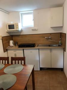 a kitchen with a table and a sink and a microwave at Pärlan 2 in Balatonboglár