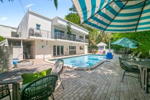 a house with a swimming pool and a patio at King Suite, Private Beach Path, Pool & Hot Tub in Boca Raton