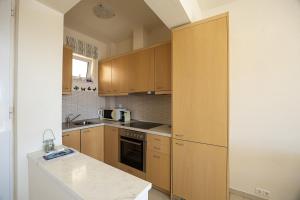 a kitchen with wooden cabinets and a counter top at Plakias Panorama Homes in Plakias