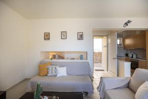 a living room with a bed and a kitchen at Plakias Panorama Homes in Plakias