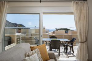 a living room with a couch and a table at Plakias Panorama Homes in Plakias +77 photos