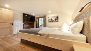 a bedroom with a large bed with a wooden headboard at Haus Georg in Leutasch