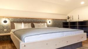 a bedroom with a large bed with a wooden headboard at Haus Georg in Leutasch