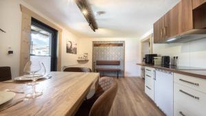 a kitchen with a table and chairs in a room at Haus Georg in Leutasch