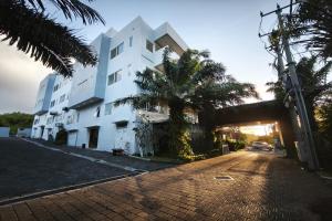 a brick road in front of a white building at Nivasa Hotel in Nusa Dua +33 photos