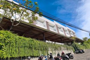 a group of motorcycles parked in front of a building at Nivasa Hotel in Nusa Dua