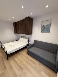 a room with a bed and a couch in it at Drymades Studio Apartment in Gjilek