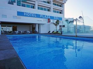 a large blue swimming pool in front of a hotel at Hotel Plaza Sol Veracruz in Veracruz +52 photos