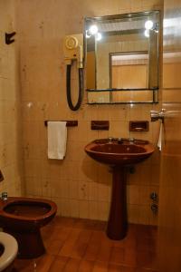 a bathroom with a sink and a toilet and a mirror at Eleven Palace Hotel in Buenos Aires +16 photos