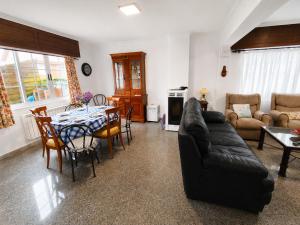 a living room with a black couch and a table at Airtegal Casa da Praia Cedeira in Cedeira