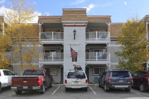 a white building with cars parked in front of it at Tannhauser 225 in Breckenridge