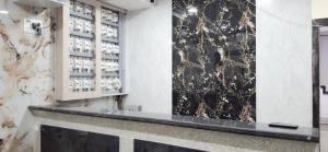 a wine tasting room with a black and white wall at Elegant Inn Hotel in Surat