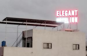 a neon sign on top of a building at Elegant Inn Hotel in Surat