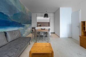 a living room with a couch and a table at Garda Dolce Vita in Torri del Benaco +19 photos